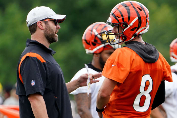 Cincinnati Bengals offensive coordinator Brian Callahan, left, talks with Cincinnati Bengals quarterback Brandon Allen (8), right, during Cincinnati Bengals training camp practice, Monday, Aug. 1, 2022, at the practice fields next to Paul Brown Stadium in Cincinnati. Cincinnati Bengals Training Camp Aug 1 0019